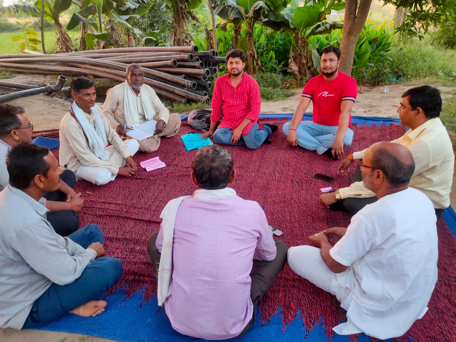Farmers seated in a circle for an evening discussion at village Kairi