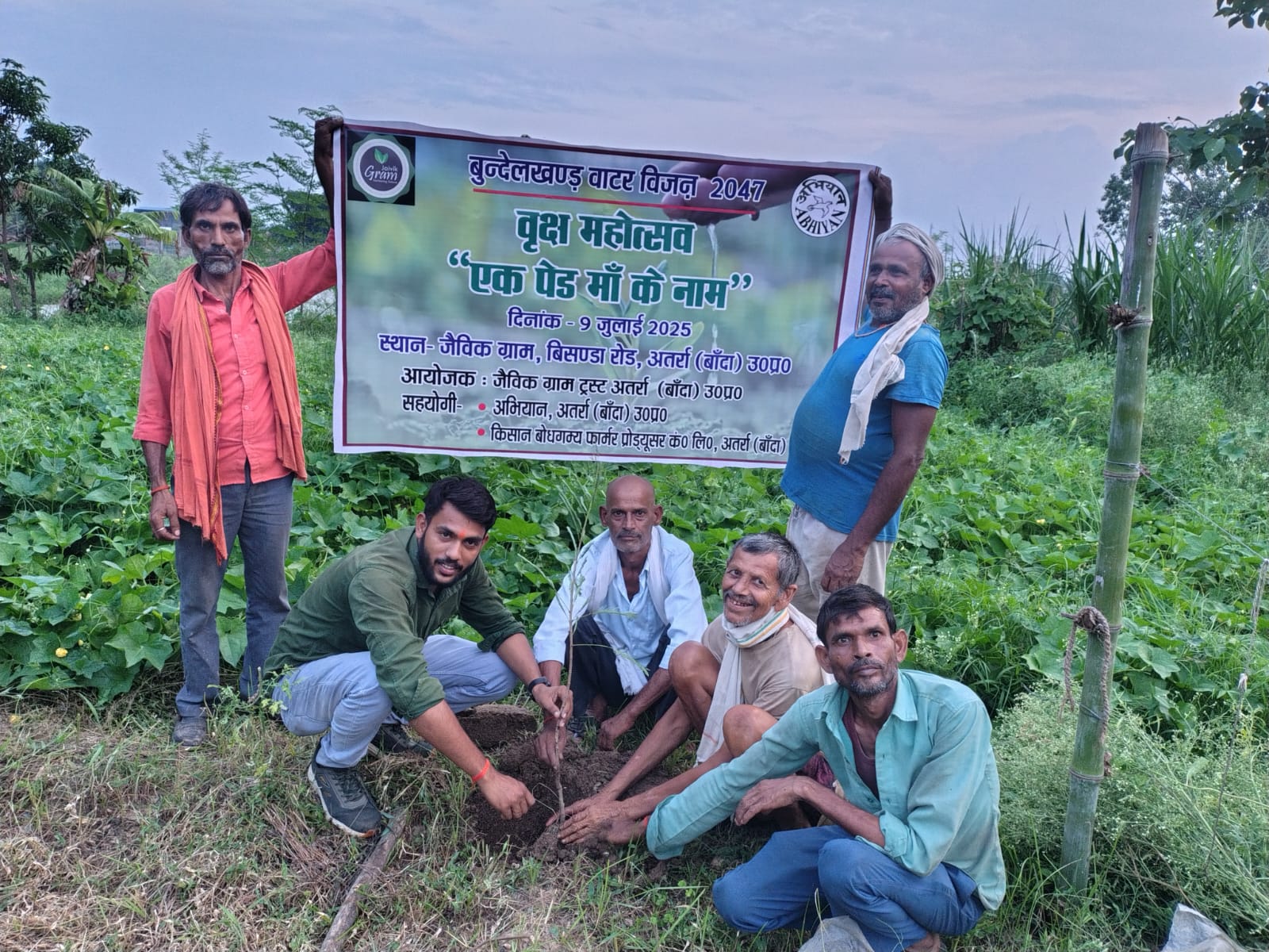 Farmers planting a sapling during the Vriksh Mahotsav tree plantation drive at Jaivik Gram on 9 July 2025