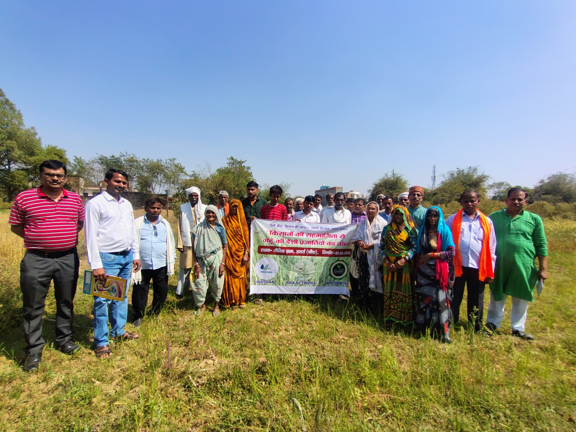 Farmers holding a banner at a native seed selection field day at Jaivik Gram, Atarra